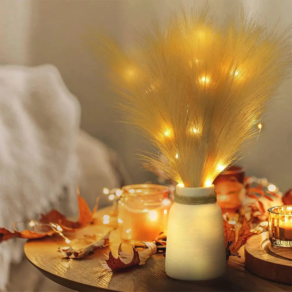 Fluffy pampas grass bouquet in a cream ceramic vase with warm LED lights for boho decor