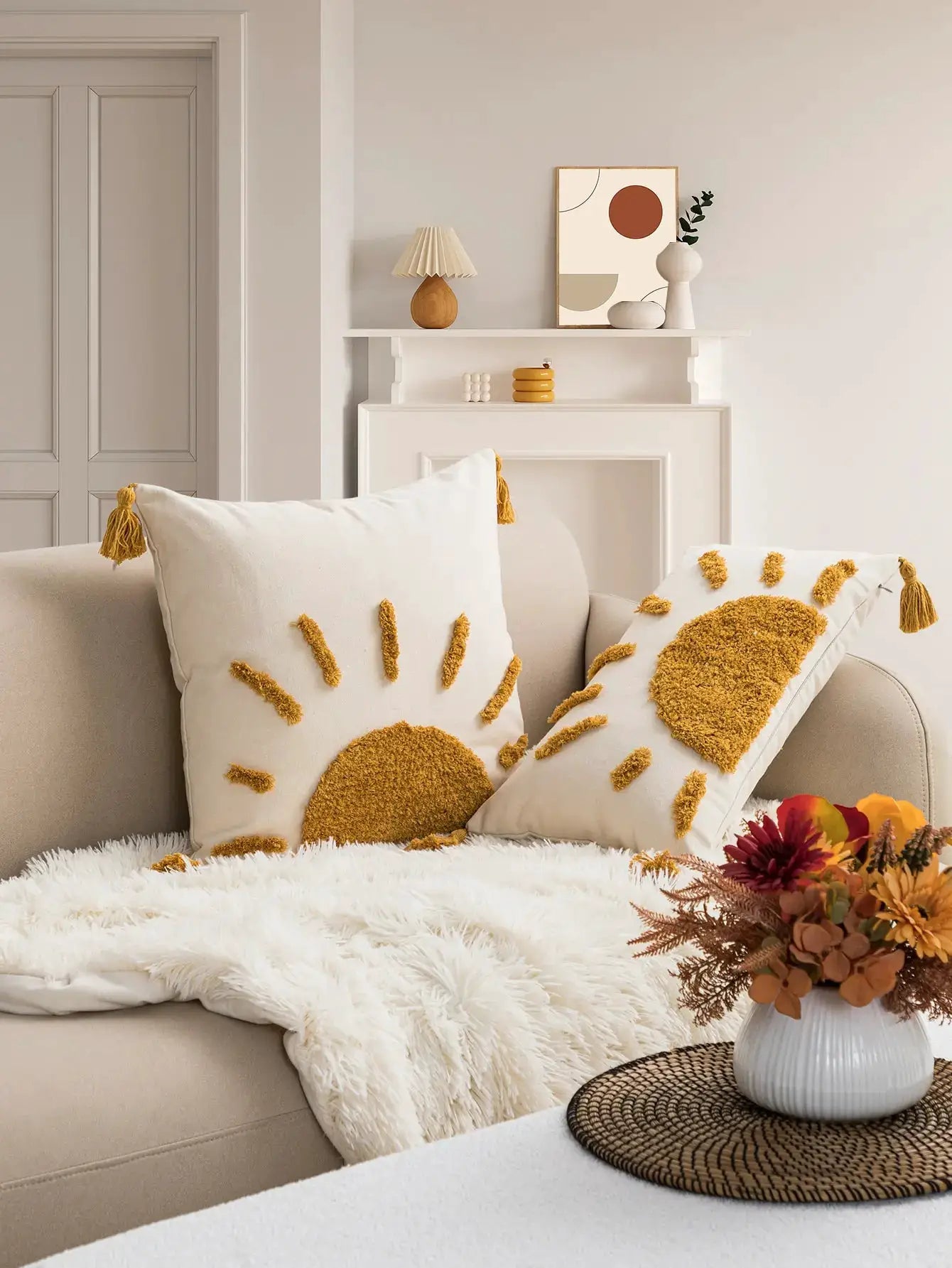 Pair of yellow sun-pattern pillowcases by Simples Market in cotton fabric with tufted sunburst and tassels on sofa.