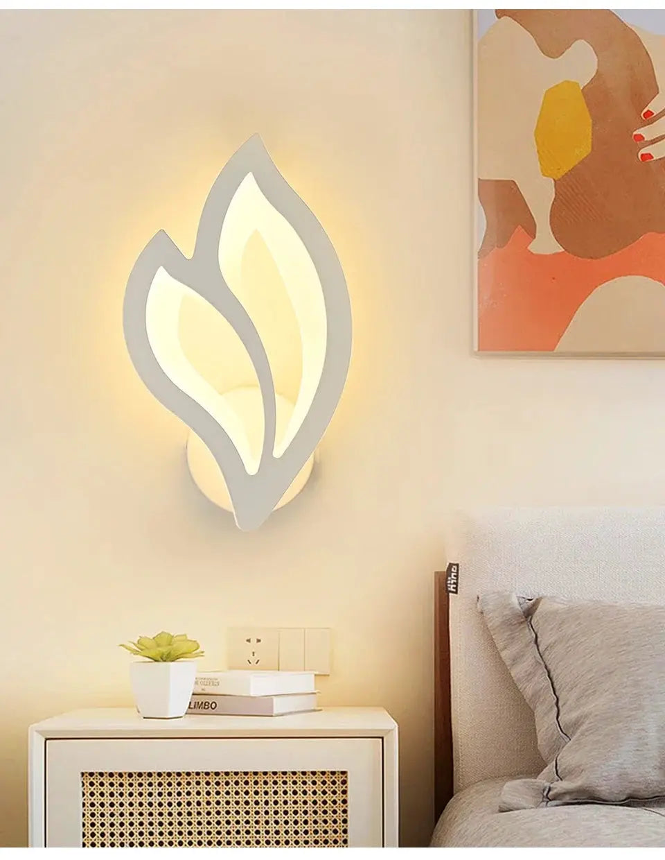 Modern LED wall lamp with leaf-shaped frame by Simples Market; warm ambient lighting for living room decor