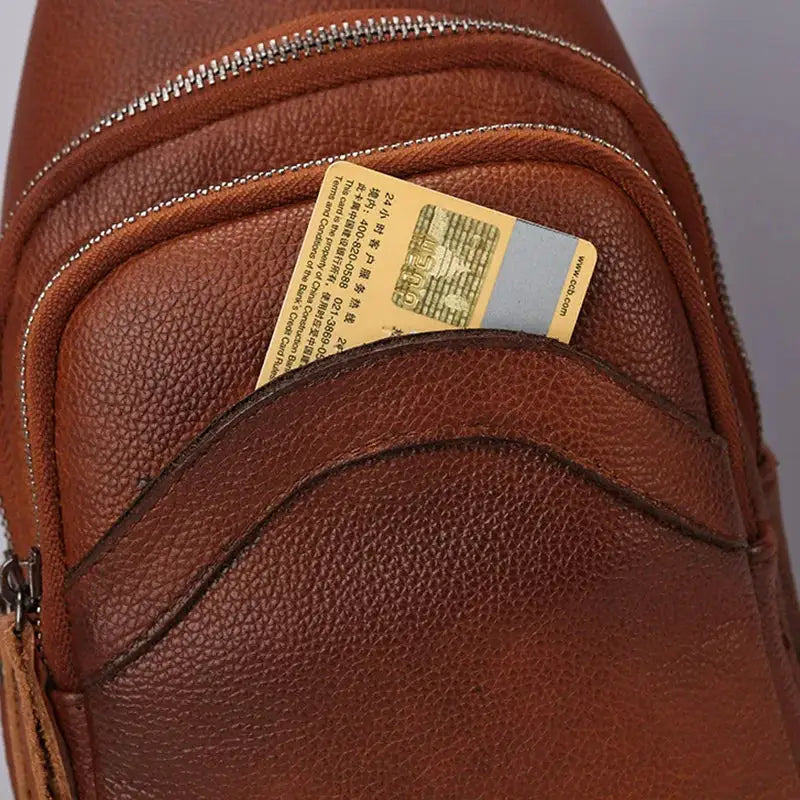 Mens leather chest bag in brown genuine top-grain leather with multiple zip pockets and card slot