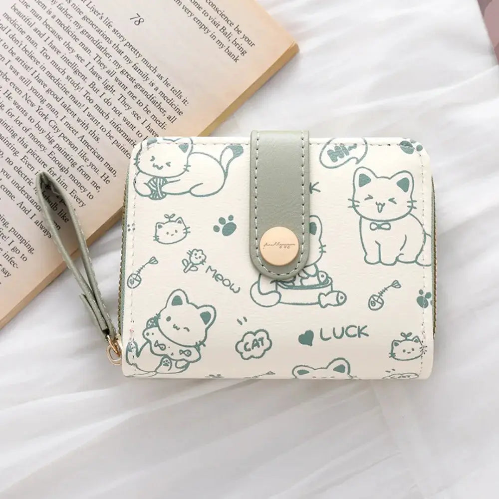 Cute cat coin purse wallet in cream PU leather with teal cat illustrations and a coordinating strap
