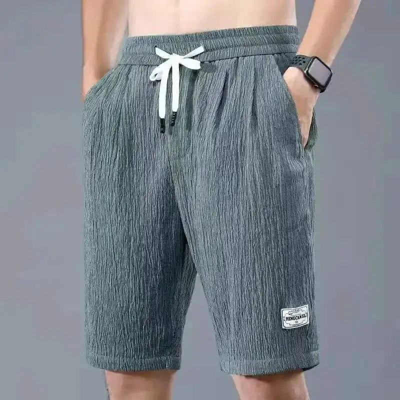 Men's ice silk casual shorts in gray textured fabric with white drawstring and pockets.
