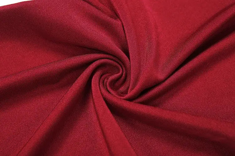 Sisterlinda red jumpsuit fabric swatch, stretchy knit texture close-up