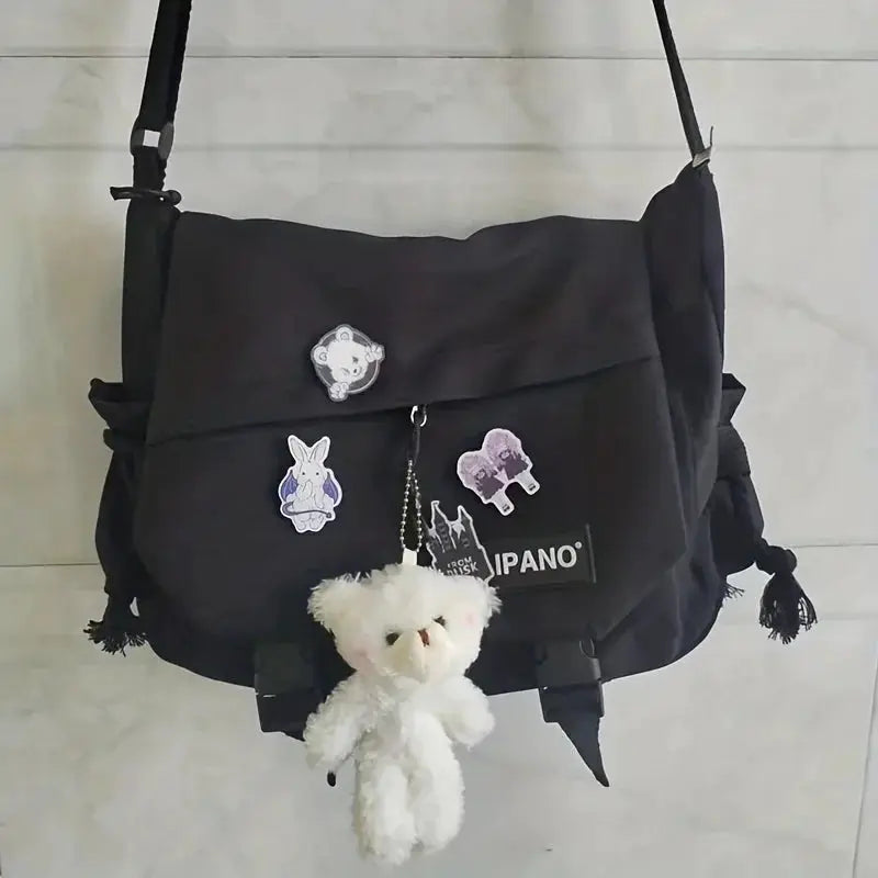 Men's black nylon crossbody bag with large capacity and adjustable strap, plus patches and plush teddy keychain