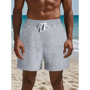 Men's gray cotton shorts with white drawstring by Simples Market on the beach
