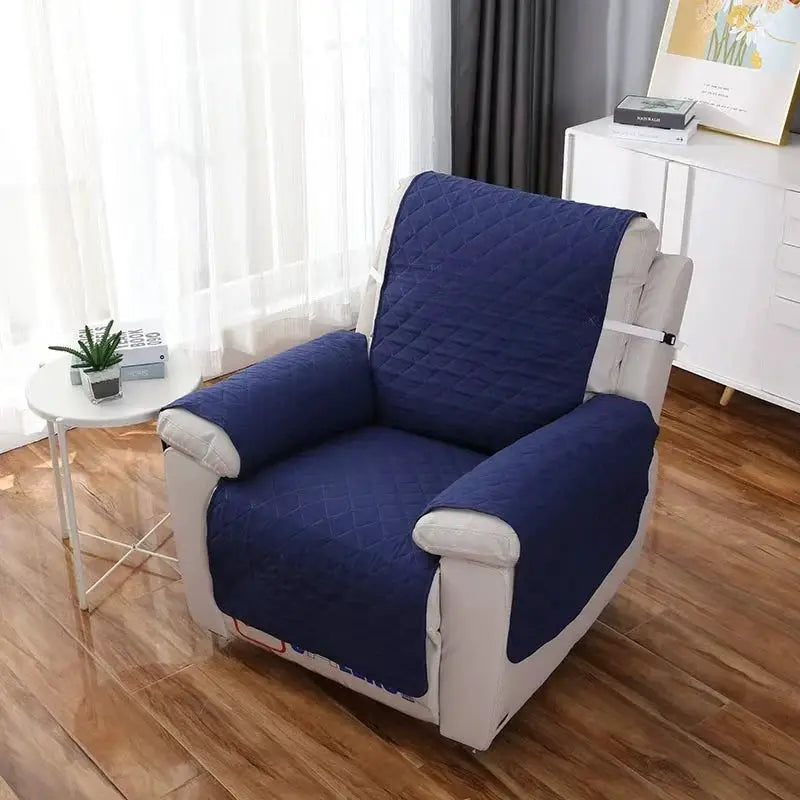 Recliner sofa cover in navy quilted fabric on beige armchair; anti-slip protective slipcover.