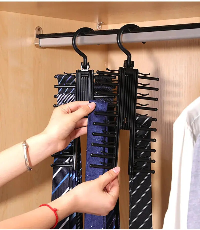 Adjustable tie storage rack, two black 360-degree rotating organizers for ties in a closet.