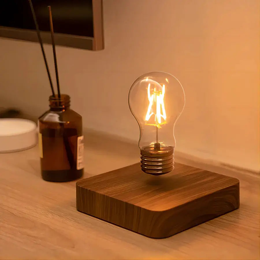 Magnetic levitation lamp with floating glass LED bulb atop a wooden base, warm glow.