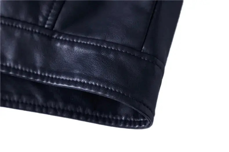 Black leather jacket sleeve close-up with stitched cuff