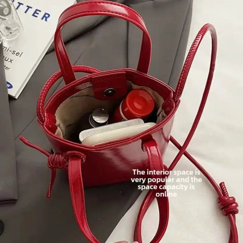 PU leather mini crossbody bag in red by Simples Market with top handles and adjustable strap.