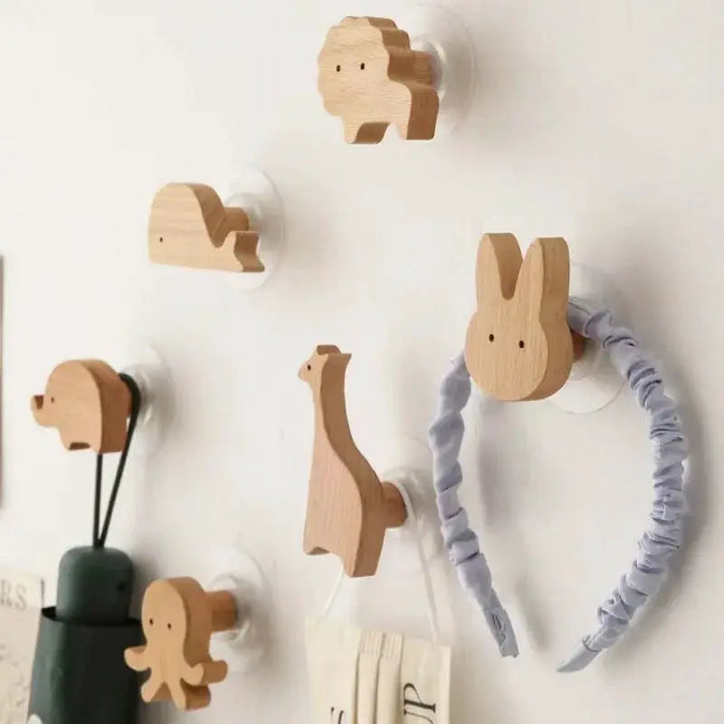 Wooden animal wall hooks set for kids' room; natural wood finish with bunny, giraffe, elephant shapes.