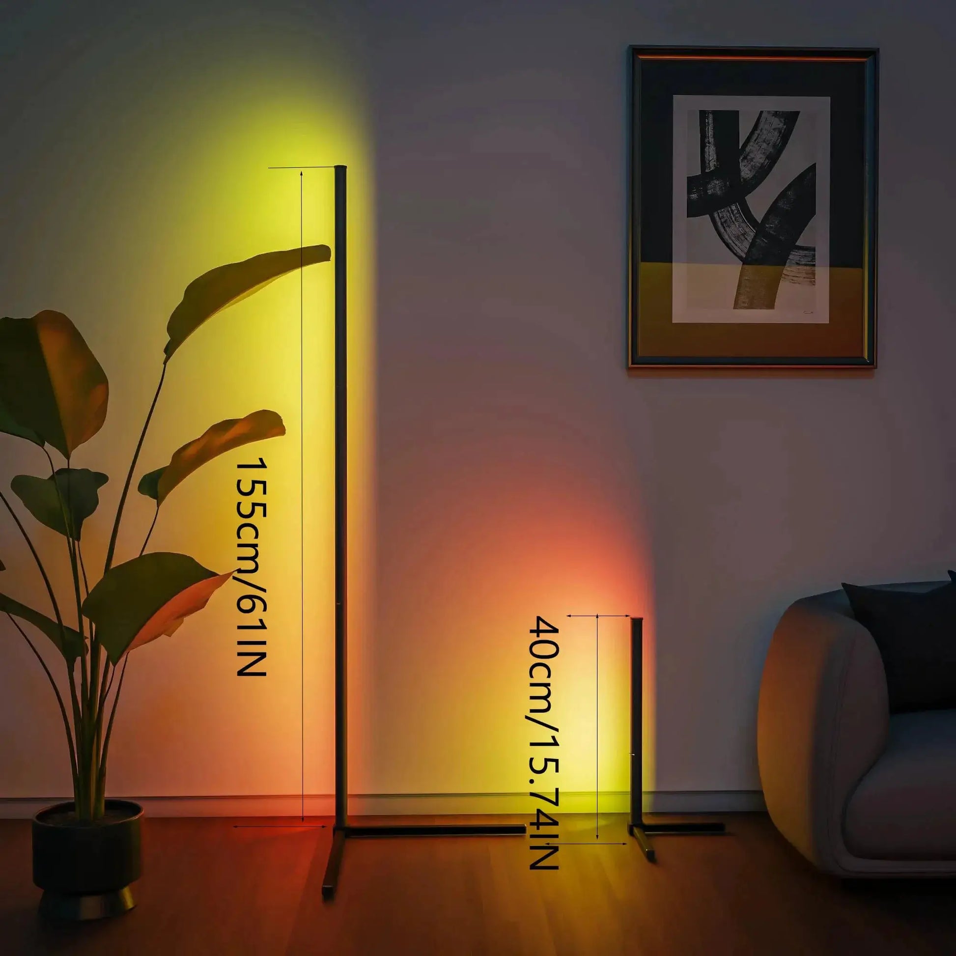 Corner floor lamp in black metal with warm yellow LED light in living room, beside a potted plant and framed wall art.