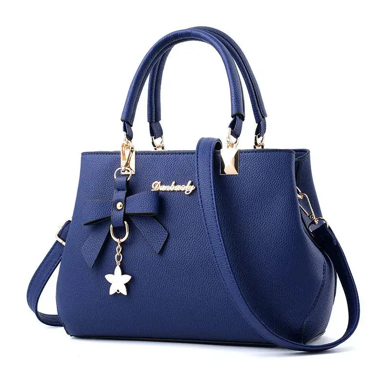 Blue leather handbag with bow detail, star charm, gold hardware, dual handles and shoulder strap – Simples Market