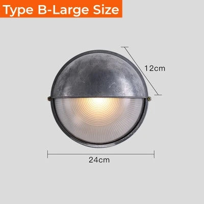 Outdoor round wall lamp with dark metal top and ribbed glass bottom, 24 cm diameter and 12 cm height.