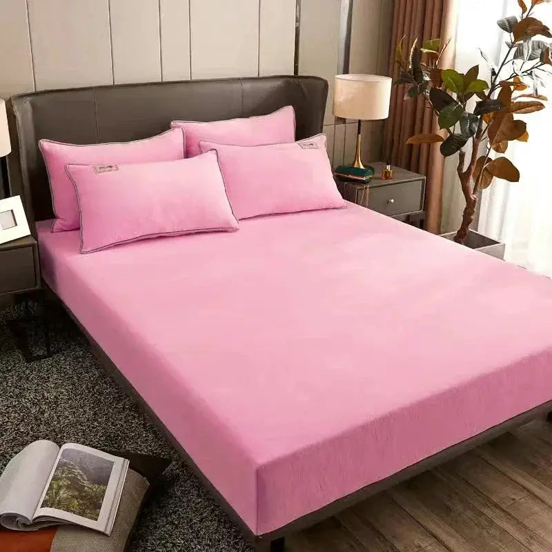 AISIRUI warm plush fitted sheet set in pink with matching pillowcases on a double bed