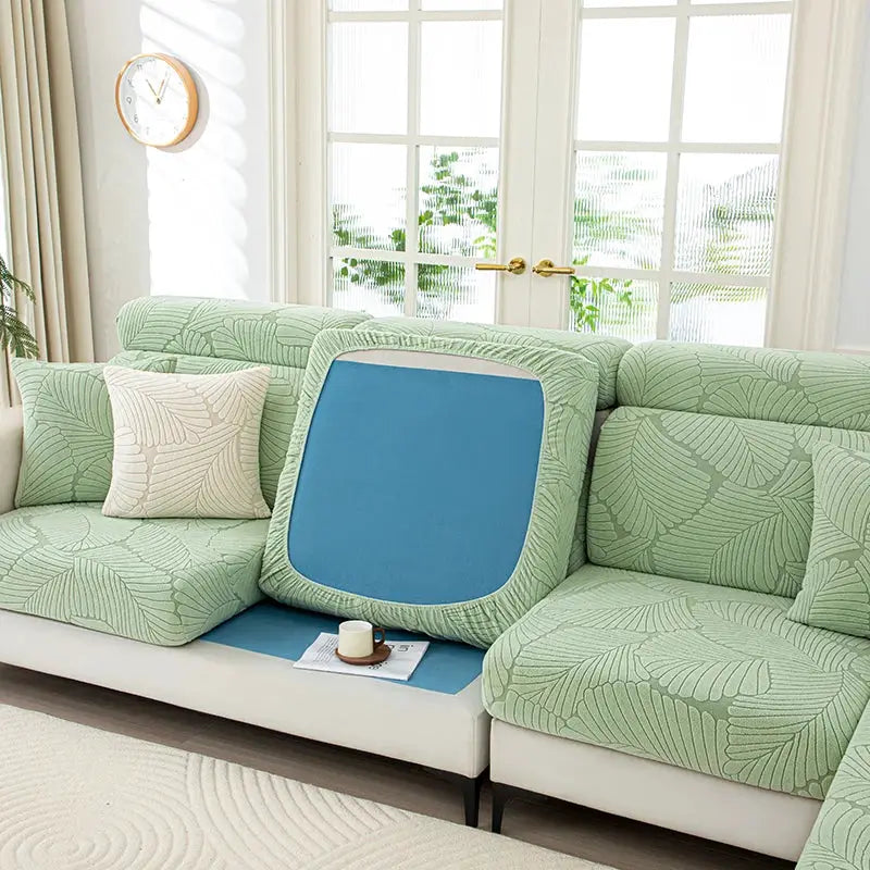Thick plush sofa cover with elastic edges in green leaf pattern and blue seat insert for pets