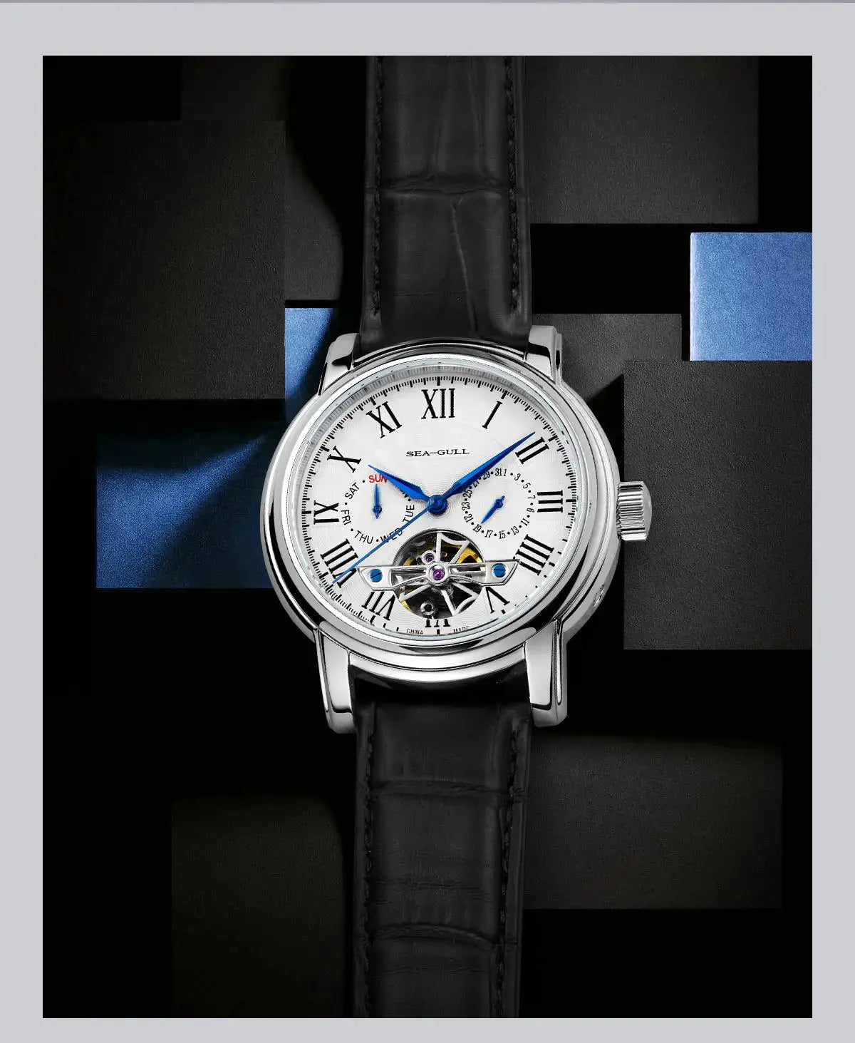 Men's automatic wristwatch with Seagull ST25 movement, silver case, white Roman dial, blue hands, black leather strap.