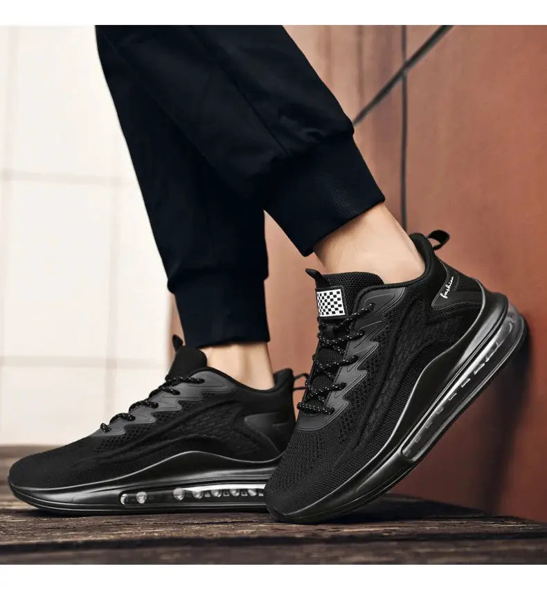 Men's black mesh sneakers with visible air-cushioned sole; pair shown.