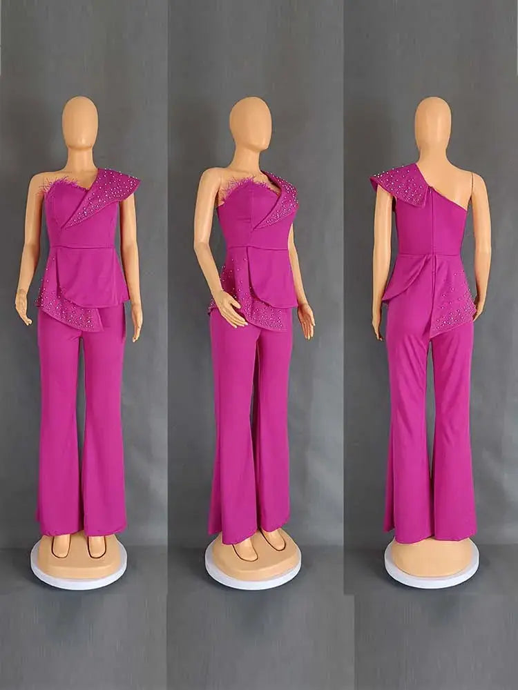 High-waist strapless jumpsuit in vivid pink with rivet collar and draped overlay, wide-leg pants