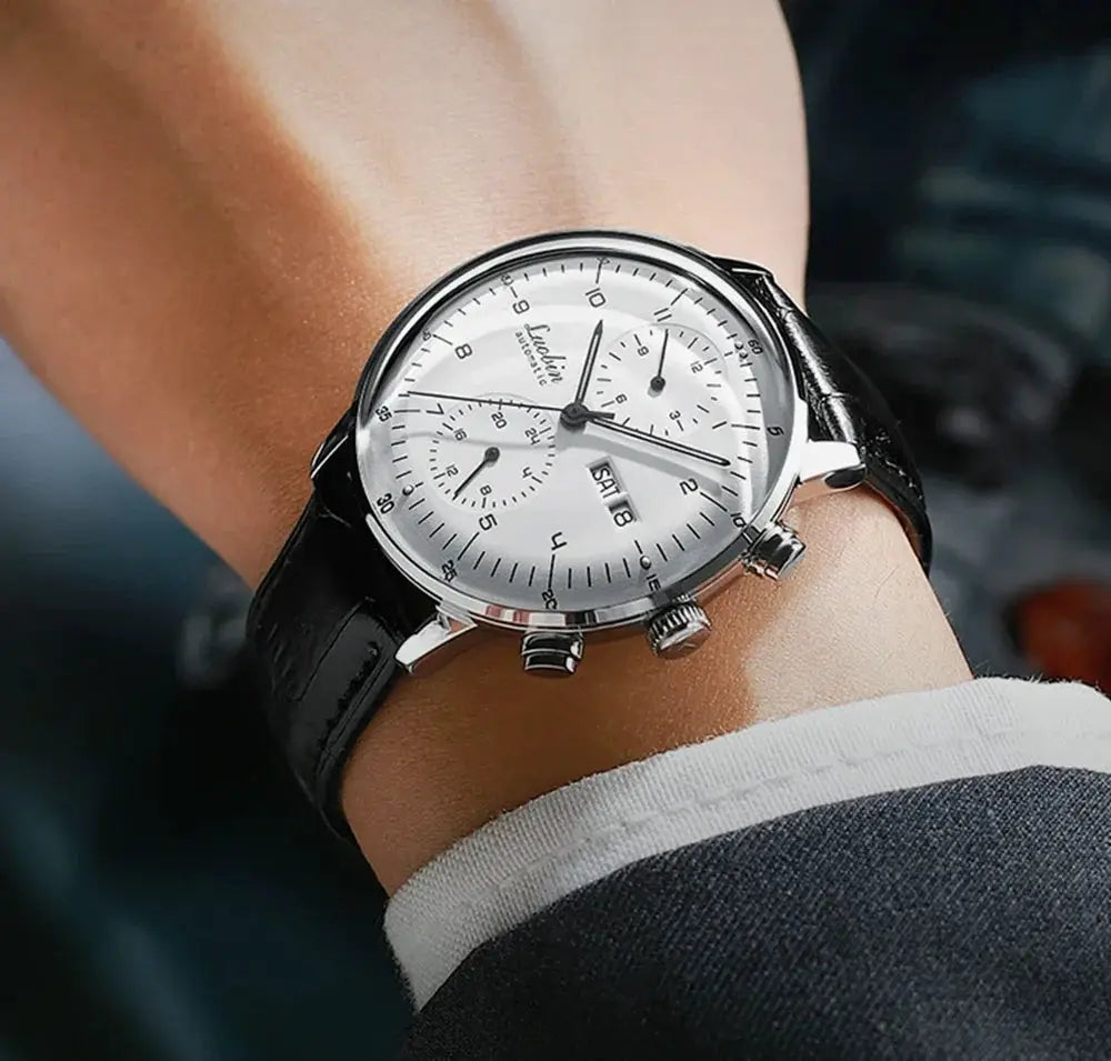 Men's automatic wristwatch with stainless steel case, white dial and black leather strap, chronograph subdials.