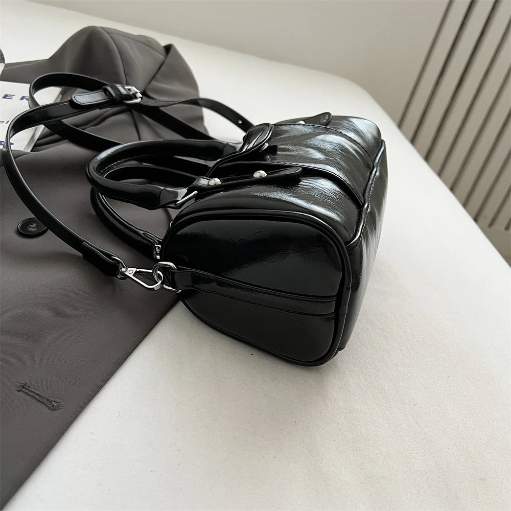 Mini top-handle bag in black patent PU leather with crossbody strap and silver hardware