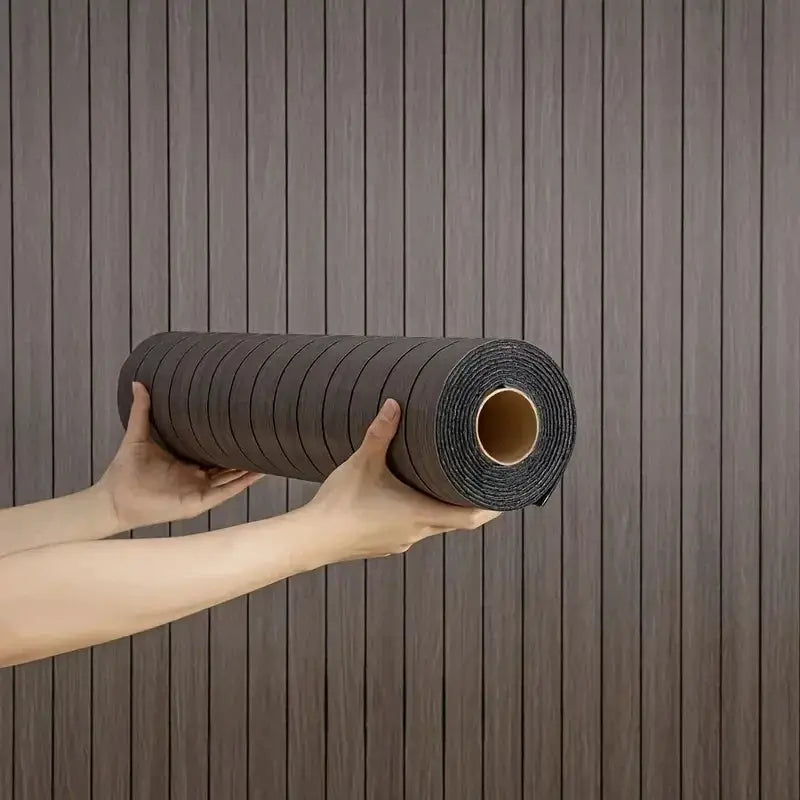 Self-adhesive wood-grain wallpaper roll in dark brown, held by hands.