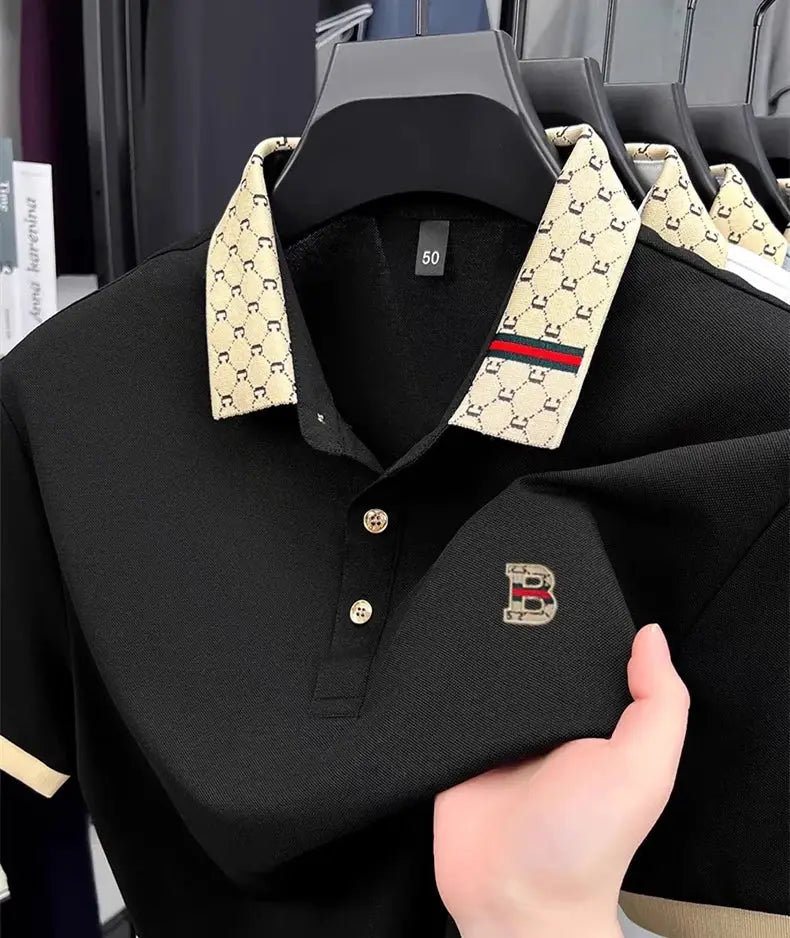 Polo shirt, black body with beige patterned collar and B embroidery on chest; lightweight, breathable short-sleeve style.
