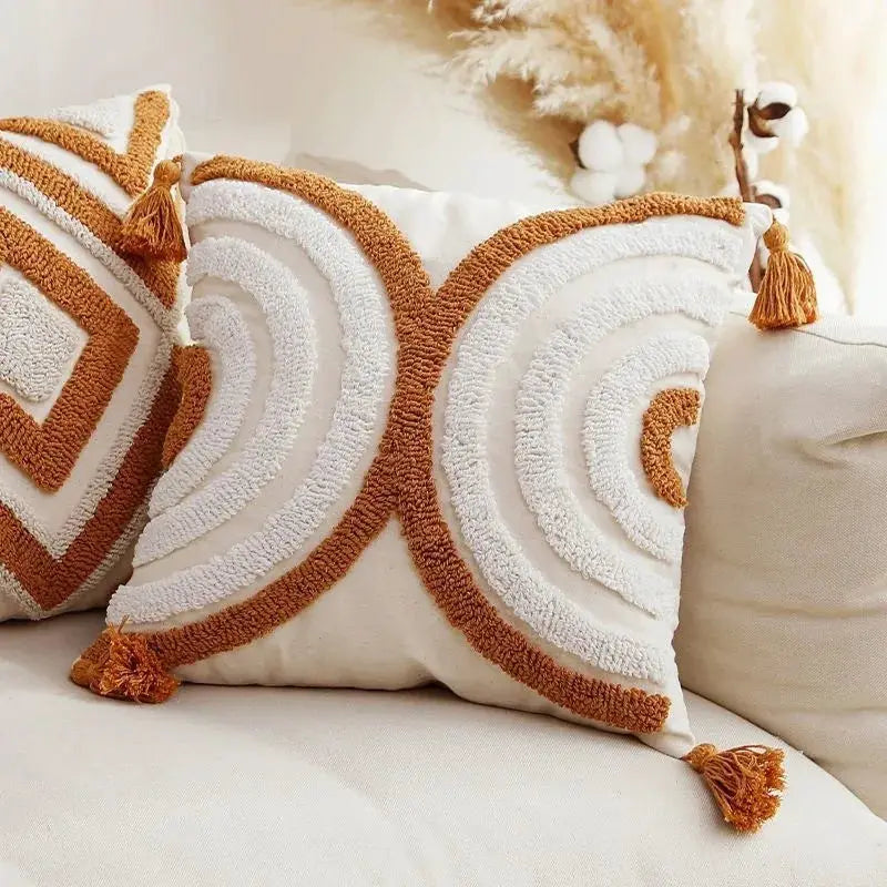 Two Bohemian geometry pillow covers with caramel and ivory embroidered pattern and tassels, by Simples Market