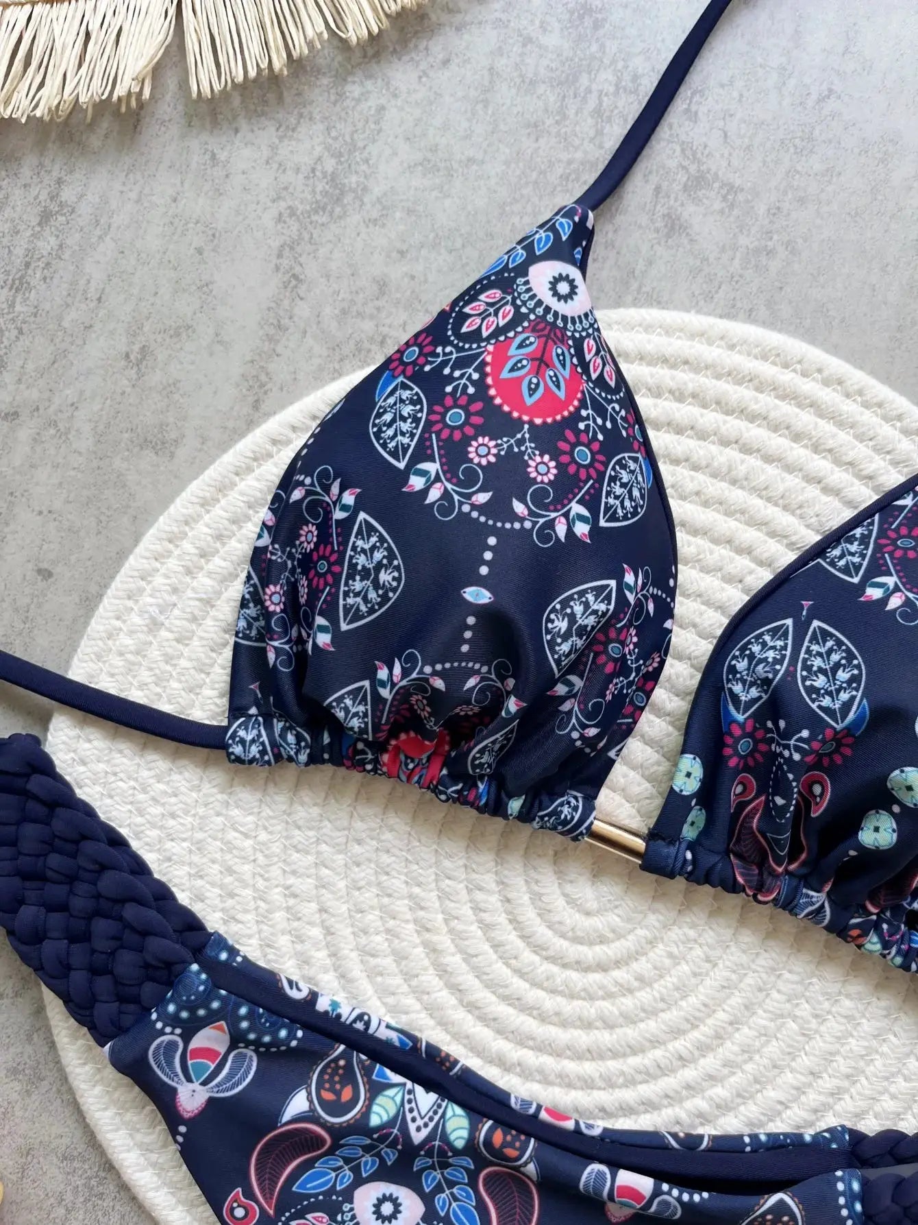 Two-piece RUOTONSEPT bikini set: navy printed halter top with pink and blue floral pattern, high-cut thong bottom