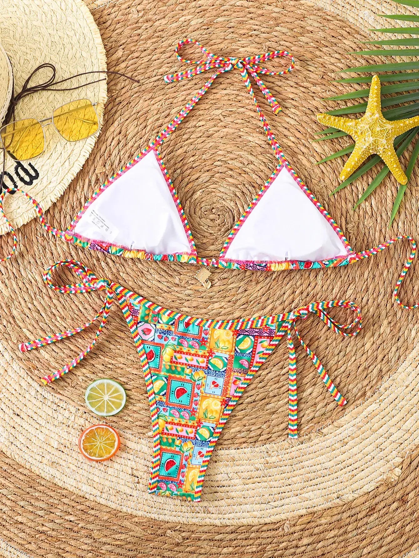Triangle bikini set with white triangle cups and rainbow braided trim; floral-print Brazilian bottoms