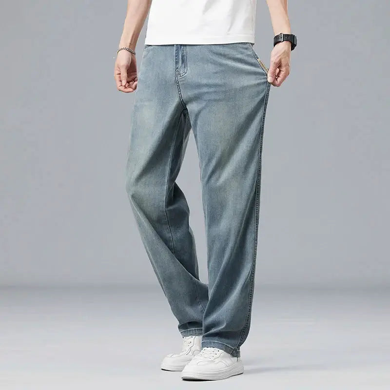 Men's denim jeans, loose straight fit in light blue wash.