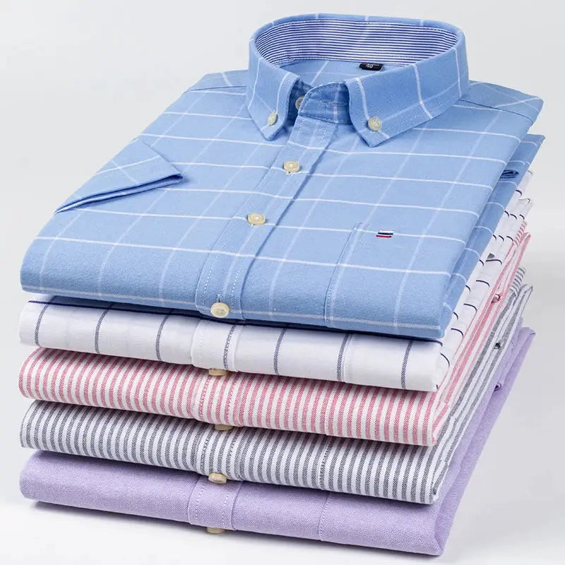 Men's 100% cotton oxford shirts stack; blue plaid top with light stripes, six shirts total