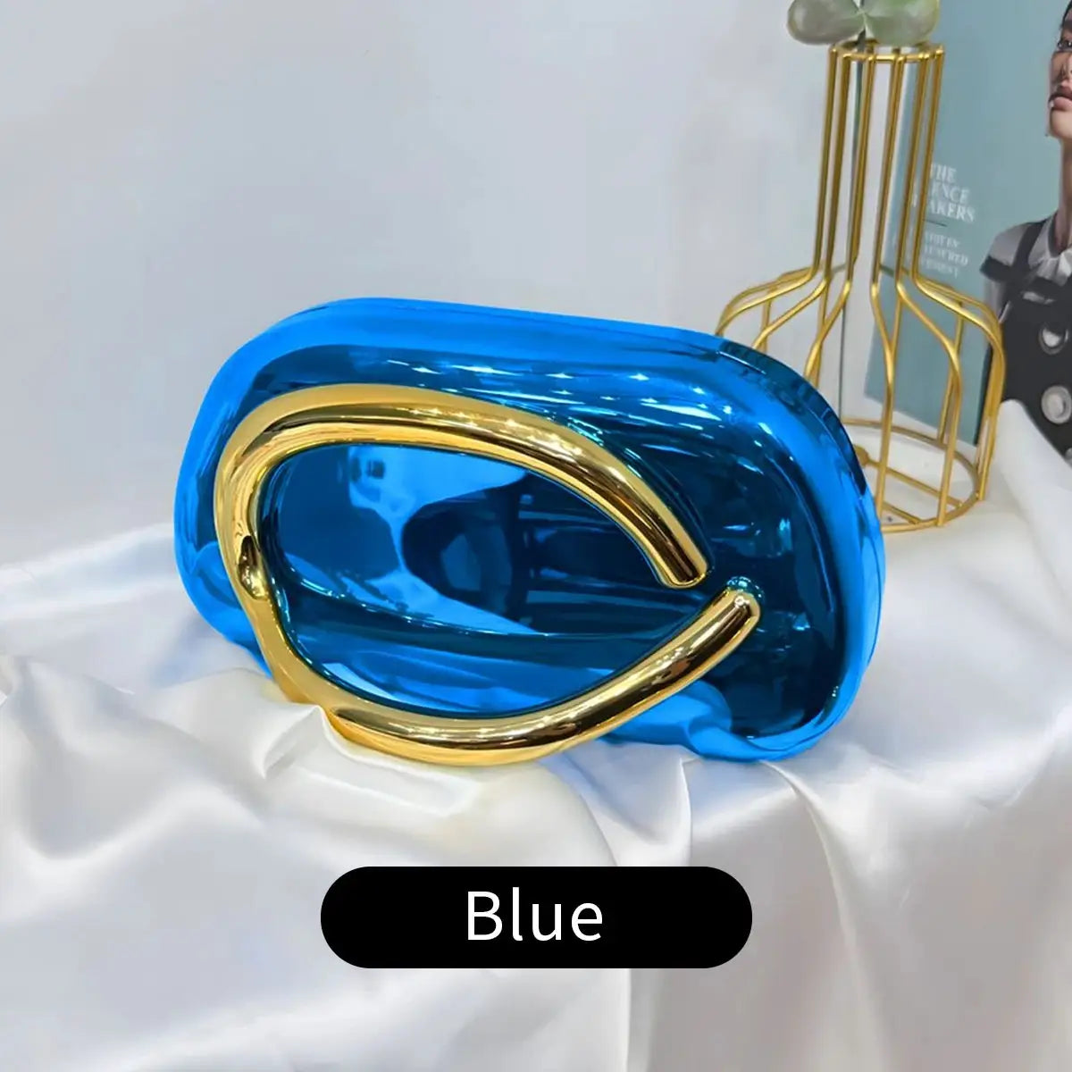 Blue acrylic box-shaped crossbody bag with gold-tone curved hardware by Simples Market