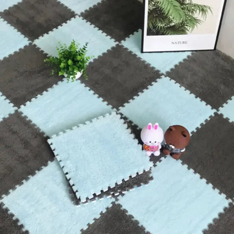 Soft EVA foam interlocking puzzle mat for babies in light blue and dark gray; includes two plush toys.