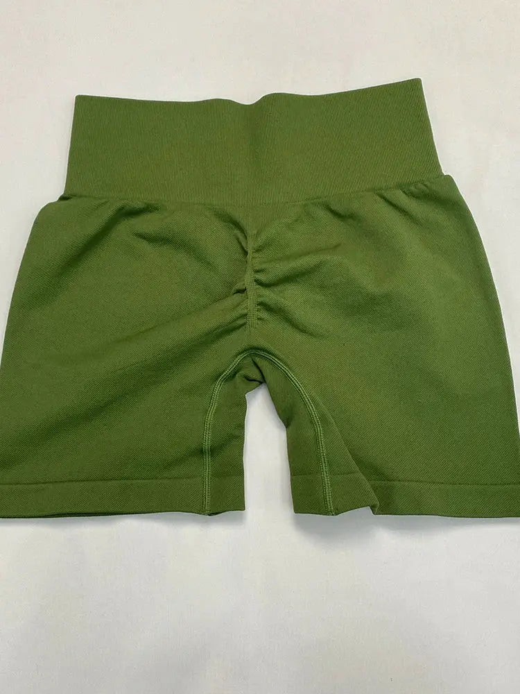 Green high-waisted women's yoga shorts with ribbed fabric and back seam detail