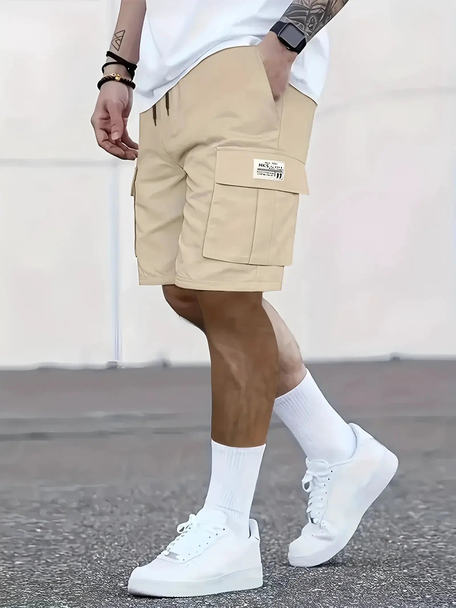 Men's beige work shorts with multiple cargo pockets and elastic waistband.