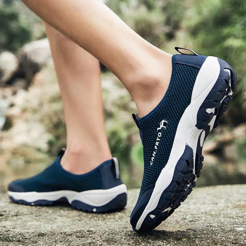 Men's navy mesh slip-on sneakers; breathable outdoor casual shoes with a white and dark rugged sole.