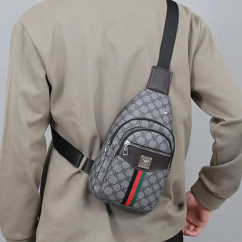 Men's crossbody messenger bag with gray monogram pattern and front zip pocket.