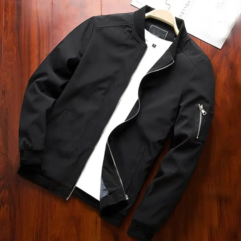 Men's black bomber jacket with front zipper, ribbed cuffs, and zip sleeve pocket.
