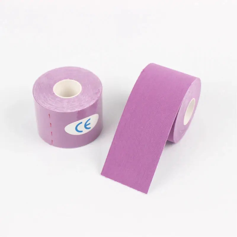 Purple kinesio tape rolls, two pieces with one partially unrolled, on white background