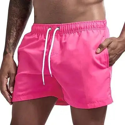 Swim trunks by Simples Market in pink with white drawstrings, quick-dry board shorts with pockets.