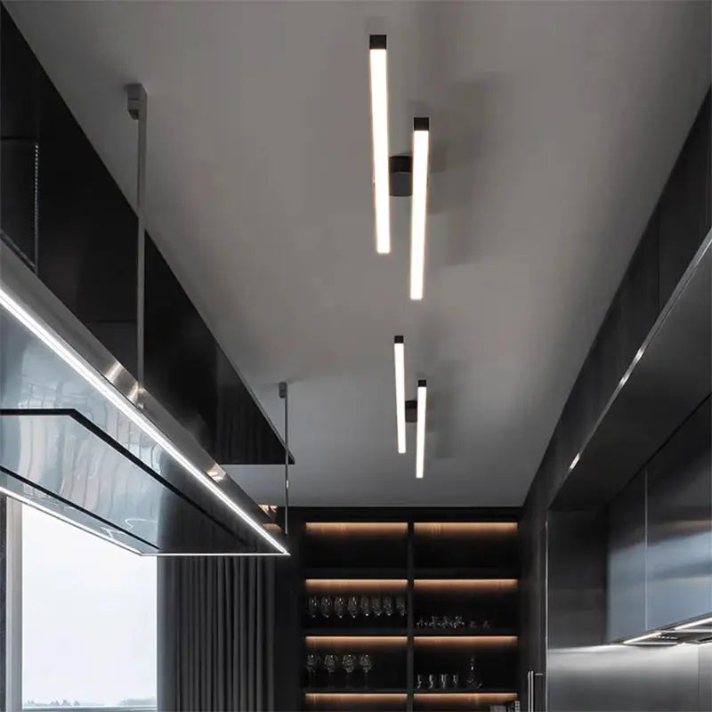 Modern LED ceiling light with three slim vertical hanging bars in a contemporary kitchen.
