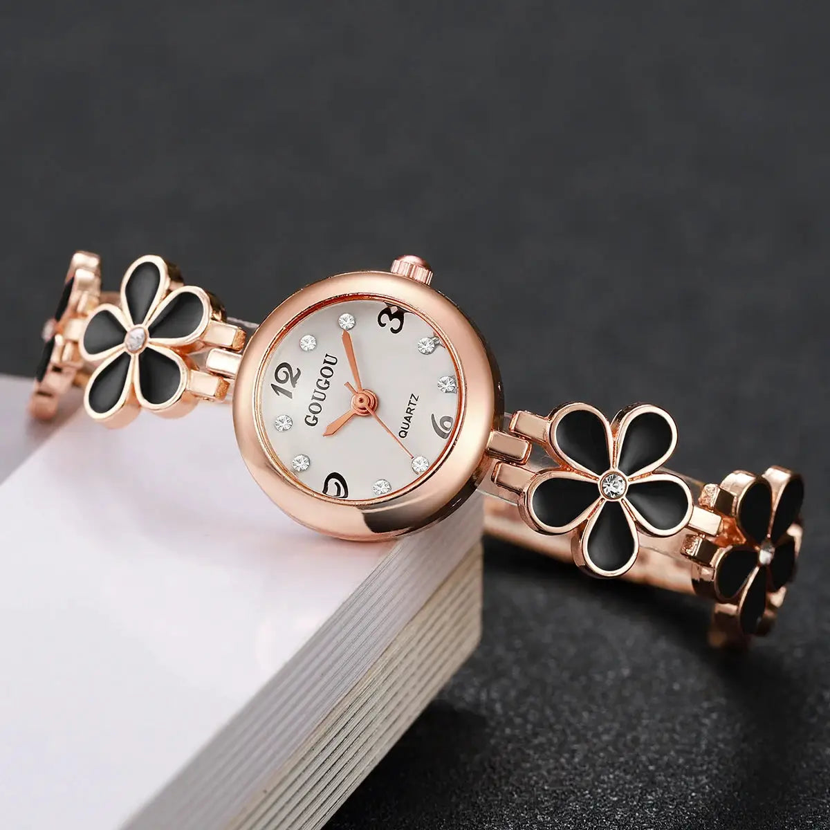 Women’s rose-gold flower bracelet watch with crystal accents and black enamel petals
