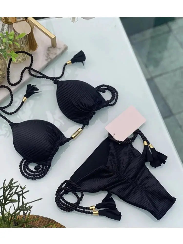 Black ribbed triangle bikini with backless top and rope-tie bottoms, tassel ends