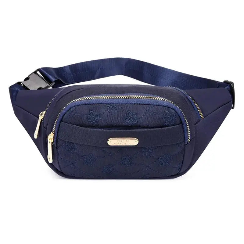 Women's waist bag by Simples Market in navy with gold zippers and embossed floral pattern