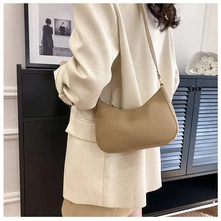 Simples Market tan single-shoulder handbag with rounded-square silhouette and gold hardware