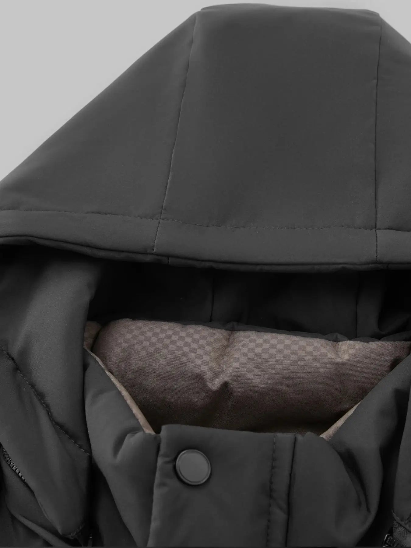 Men's black quilted jacket with snap front closure and warm brown lining
