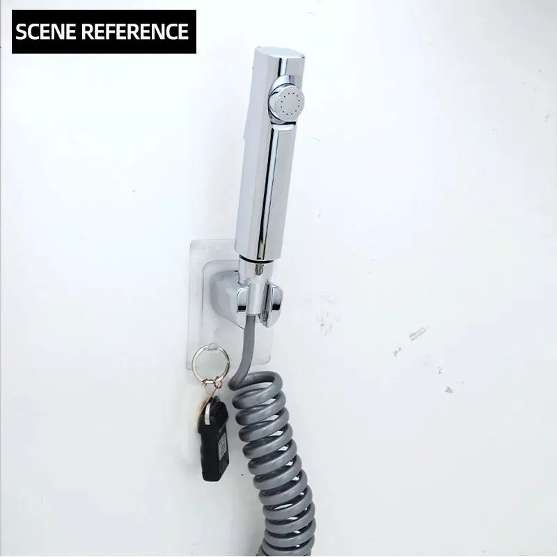Chrome handheld bidet sprayer with gray coiled hose and wall-mount bracket