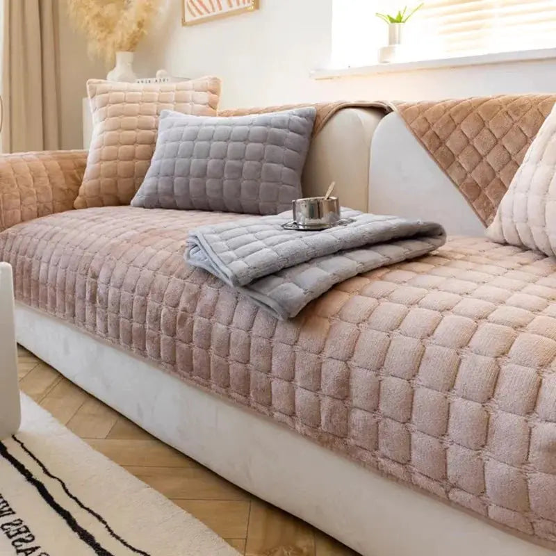 Flannel quilted sofa cushion cover in pink with grey cushions on a living room sofa