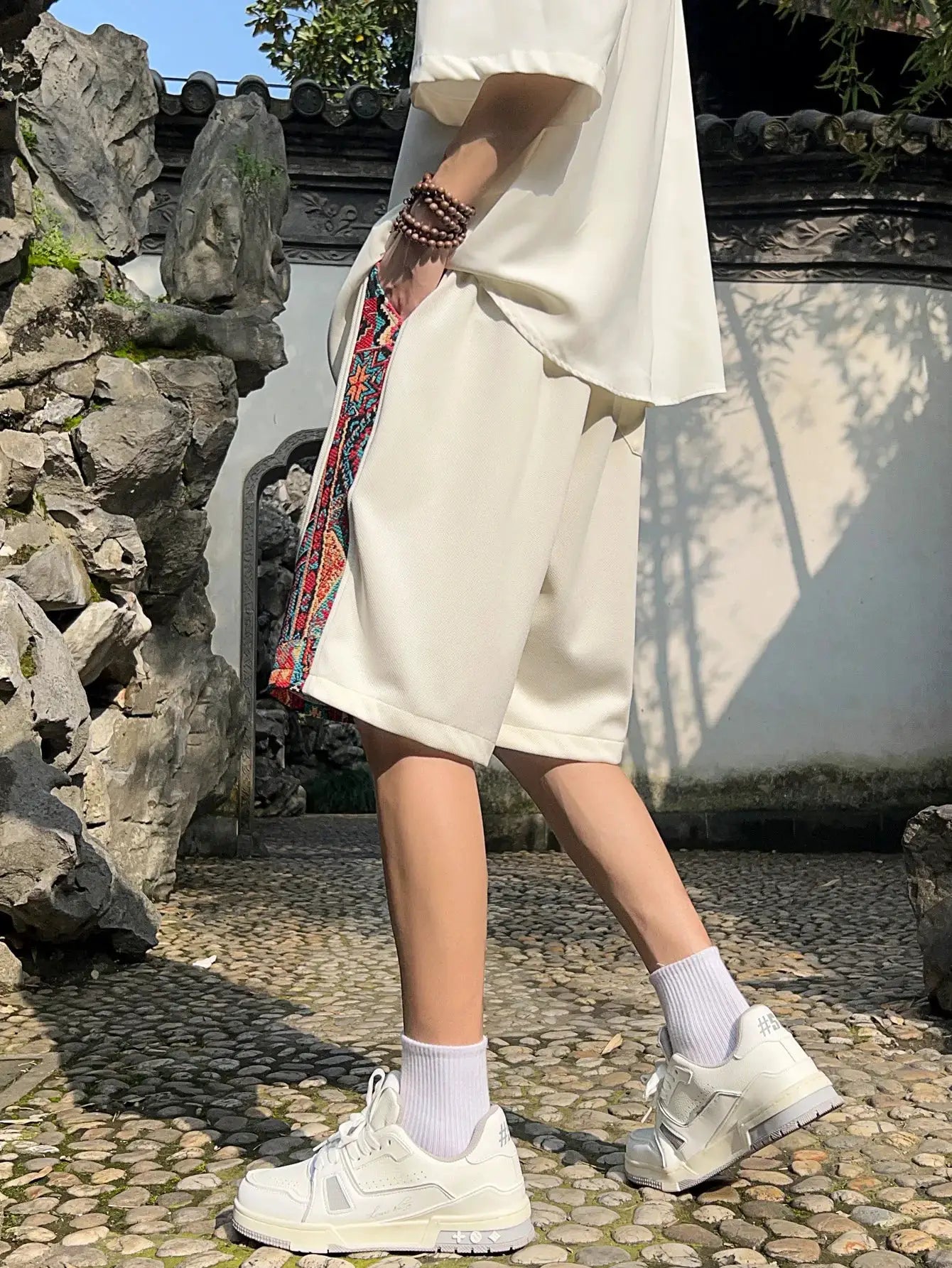 Men's beige shorts with colorful ethnic embroidery side stripe and pockets